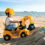 asian-boy-play-excavator-toy-beach_167657-168